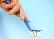 Photo: Gloved hand with brush Gloved hand with brush