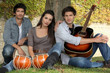 three musicians at the foot of a tree