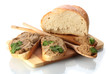 Fresh pate on bread on wooden board isolated on white