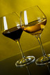 Two glasses of wine on a yellow background