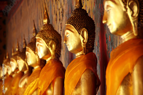 Photo: golden Buddha image arrange in arcade, Bangkok, Thailand golden Buddha image arrange in arcade, Bangkok, Thailand
