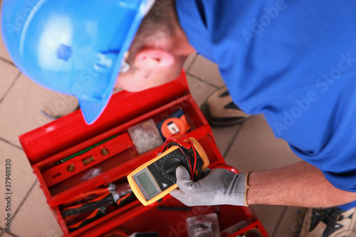 Photo: Man with electricity measurer Man with electricity measurer