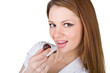 Photo: Beautiful young woman eating chocolates Beautiful young woman eating chocolates