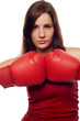 Confident young woman with boxing gloves