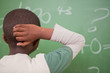 Schoolboy thinking with his hand on his head