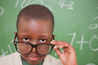 Schoolboy looking over his glasses