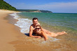 Young caucasian couple sunbathing at the beach