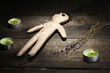 Voodoo doll boy on a wooden table in the candlelight