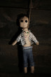 Hanged doll voodoo boy on wooden background