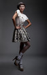 Graceful young woman posing on podium in retro clothes