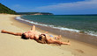 Young caucasian couple sunbathing at the beach