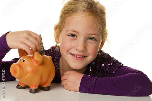 Photo: Kind mit Sparschwein. Dollar sparen Kind mit Sparschwein. Dollar sparen