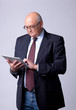 portrait of a successful senior man with tablet