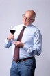 portrait of a successful senior man with glass of wine