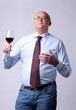 portrait of a successful senior man with glass of wine