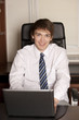 Smiling businessman with laptop