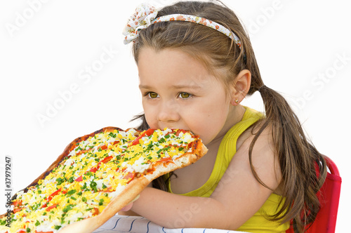 Photo: Little girl eating pizza Little girl eating pizza