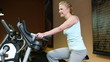 Woman on hometrainer in gym