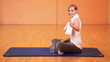 Exhausted woman in gym holding thumbs up
