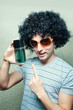 Funny guy in wig and eyeglasses with perfume bottle