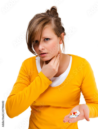 Photo: Suffering woman holding pills isolated on white background Suffering woman holding pills isolated on white background