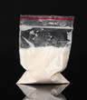 Cocaine in package on black background