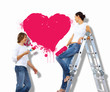 Foto: Young couple with paint brushes together Young couple with paint brushes together