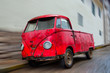 Old Wrecked Red Van Parked on Street with Blur
