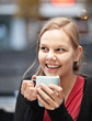 Pretty young woman with cup of chocomilk