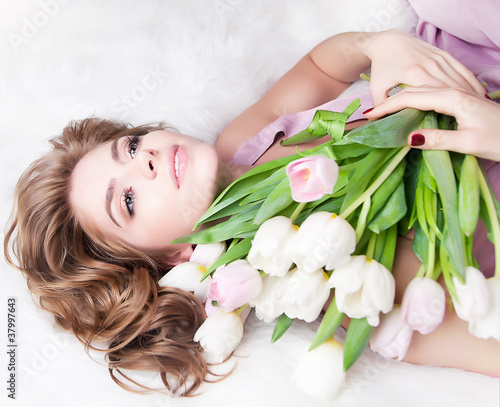 Photo: Dreaming lovely young girl with bouquet of fresh tulips Dreaming lovely young girl with bouquet of fresh tulips