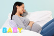 Pregnant woman BABY word in front.