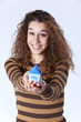 Young woman holding a small house Young woman holding a small house