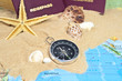 Ausweise mit Sand, Kompass, Muscheln und Weltkarte