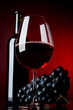A glass full of wine and bottle