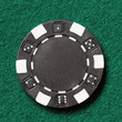 black poker chip on a table