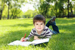 Foto: Portrait of a boy with a book in the park Portrait of a boy with a book in the park