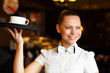 Foto: Portrait of young waitress holding a tray Portrait of young waitress holding a tray