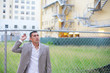 Businessman by an empty land lot