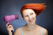 Redhead woman drying her hair