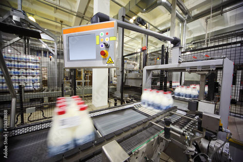 Photo: Conveyor with wrapped milk bottles at big factory Conveyor with wrapped milk bottles at big factory