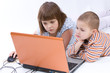 siblings playing with notebook