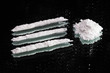 Cocaine drugs heap and lines still life on a dark mirror, close