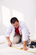 Casual man laying isolation foam beneath flooring