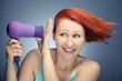 Redhead woman drying her hair