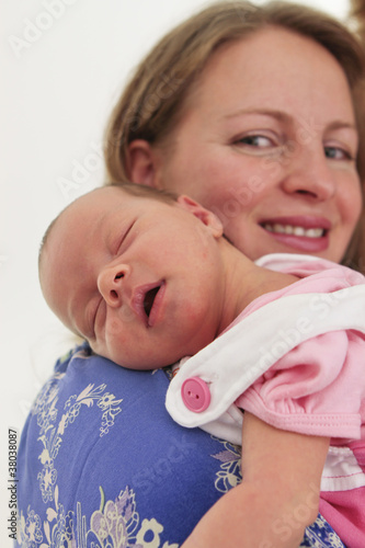 Photo: Mom proudly holding her baby on sholders Mom proudly holding her baby on sholders