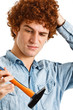Portrait of a clumsy man trying to use an hammer