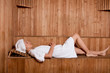 Photo: Young woman relaxing in a sauna Young woman relaxing in a sauna
