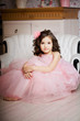 Photo en ligne au meilleur prix Girl in the nursery in pink dress