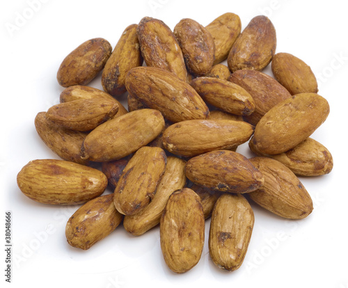 Photo: Raw cacao beans isolated on white background. Raw cacao beans isolated on white background.