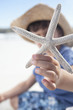 Close up of boy holding starfish on beach